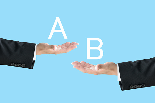 Business man's hands with alphabet A and B