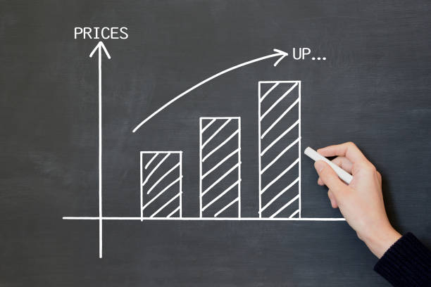 istock Handwritten graph for price on blackboard and human's hand 1492842929