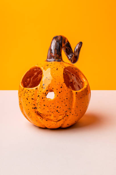 istock Candlestick in the shape of a pumpkin. Pumpkin on orange background 1492844247