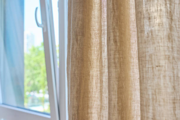 istock Gray linen natural curtains on window, close-up 1492845277