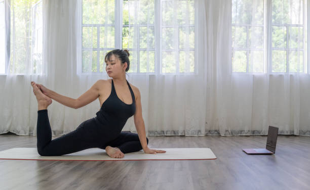 istock Female learning yoga online with a digital tablet 1492846221