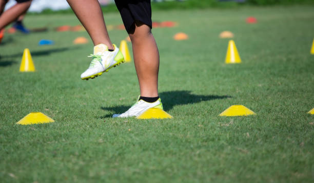 istock Athlete practicing running football sport on field equipment 1492846670