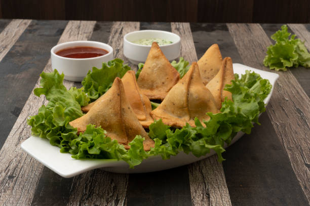 istock Potato Samosa Snacks on textured Background. Indian Ramadan Food, Pakistani Iftar Meal. 1492849486