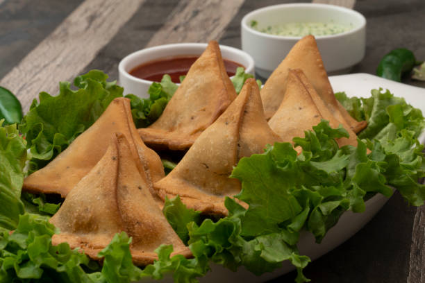 istock Potato Samosa Snacks on textured Background. Indian Ramadan Food, Pakistani Iftar Meal. 1492849568