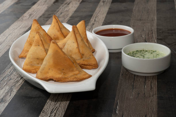 istock Potato Samosa Snacks on textured Background. Indian Ramadan Food, Pakistani Iftar Meal. 1492849600