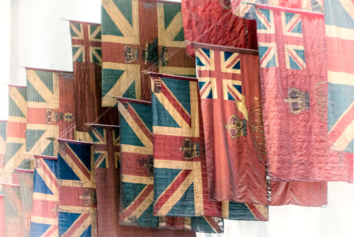 Battle Honours displayed in the Guards’ Chapel in Birdcage Walk in Central London. The colours lining the walls of the chapel have been carried by the Foot Guards battalions since 1770, and some date from before the Union with Ireland which explains why the Union Flag does not have the diagonal red bars in some cases.