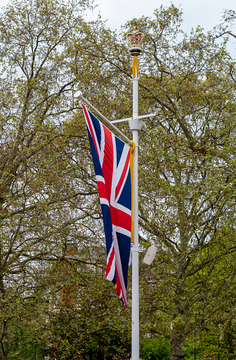 A Union Flag on a flagpole in The Mall, Central London, on the day after the Coronation of King Charles III. The flags were displayed both sides of The Mall for its full length and made a stirring sight.