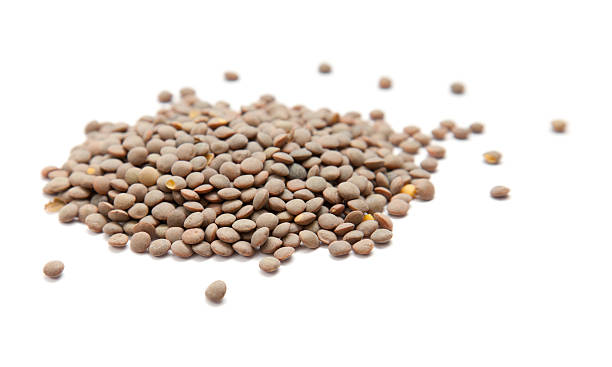 istock handful of brown lentils isolated on white background 149285308