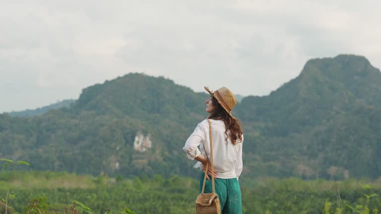 Woman looking at Khao Sok National park mountains