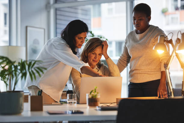 istock Innovation, planning and leadership while team of creative entrepreneurs use laptop internet for marketing research for inspiration while talking strategy. Female empowerment through collaboration 1492853192