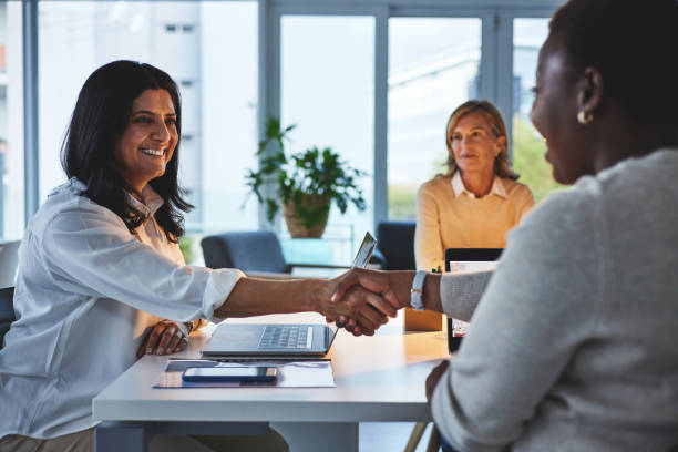 istock Handshake, collaborate and agree on a successful deal while introducing, welcoming or congratulating colleagues for leadership promotion. Diverse businesswoman celebrating growth and partnership 1492853207