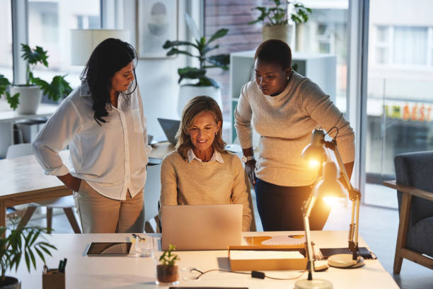 istock Innovation, planning and leadership while team of creative entrepreneurs use laptop internet for marketing research for inspiration while talking strategy. Female empowerment through collaboration 1492853211