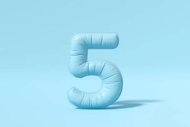 Photo of Number 5 balloon on blue background