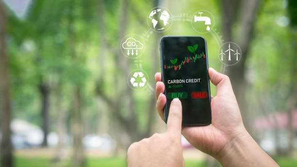 Businessman using smartphone to exchange carbon credits via modern new app clean technology renewable energy world concept Businessman using smartphone to exchange carbon credits via modern new app clean technology renewable energy world concept carbon county utah stock pictures, royalty-free photos & images