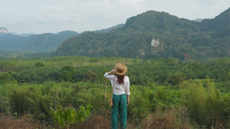 Woman looking at Khao Sok National park mountains