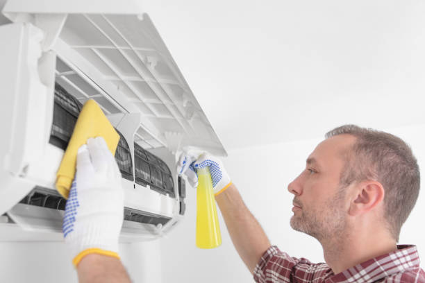 istock Service guy cleaning and maintaining air condition unit. 1492857681