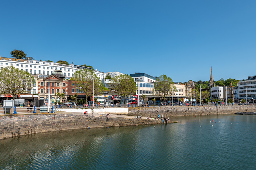 Torquay, UK. 20 May 2023.  People on the large slipway into Torquay Harbour in Devon.