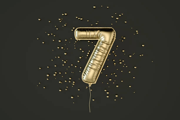 istock Number 7 balloon foil gold colored on black background 1492859847