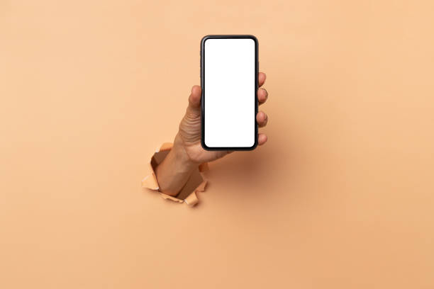 istock man hand holding a blank screen smart phone on a brown background 1492863109