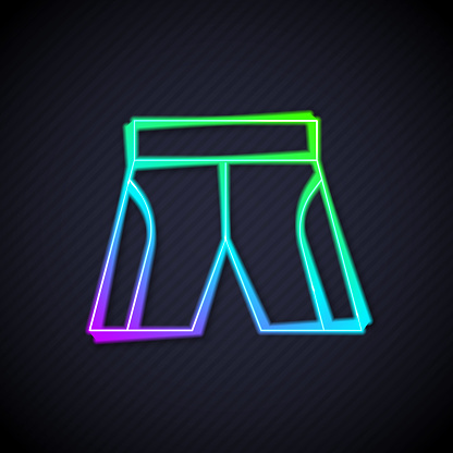 Glowing neon line Short or pants icon isolated on black background. Vector.