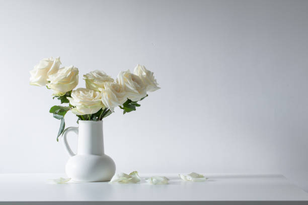 istock bouquet of white roses in jug on white background 1492866080