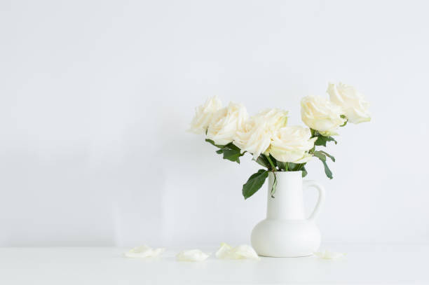 istock bouquet of white roses in jug on white background 1492866091