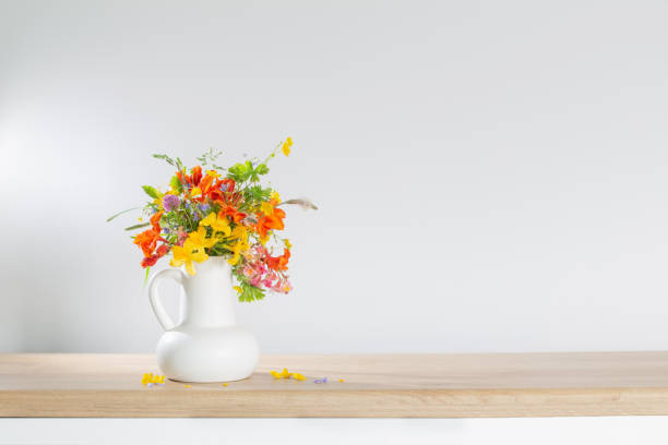 istock summer flowers in white jug on wooden table 1492866664