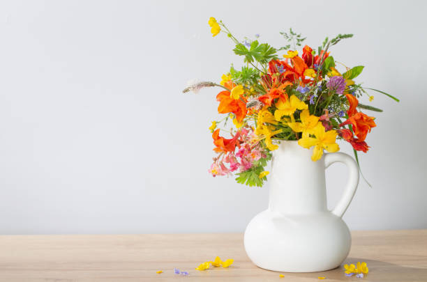 istock summer flowers in white jug on wooden table 1492866682