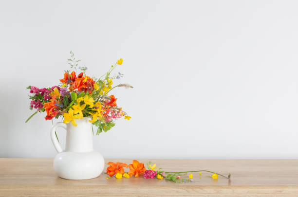 istock summer flowers in white jug on wooden table 1492866759