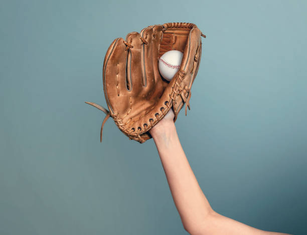 istock Hand in leather baseball glove caught a ball on dark gray background 1492866850