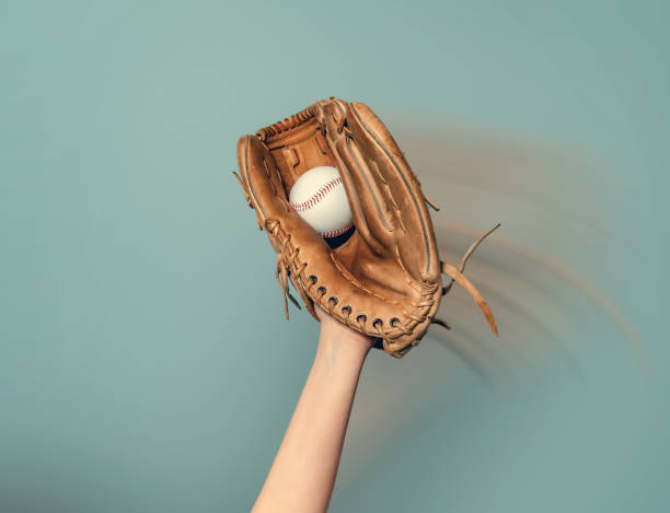 istock A baseball glove on his hand catches a white game ball 1492866861