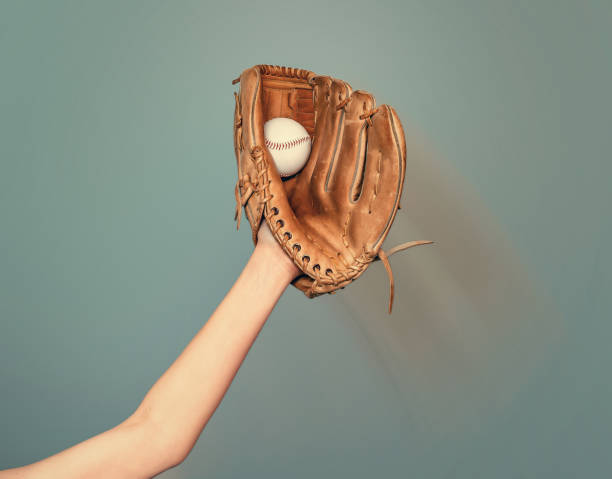 istock A baseball glove on his hand catches a white game ball 1492866880