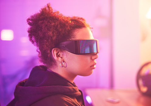 Metaverse, virtual reality and girl for gaming innovation, vr media and neon lighting at night. Female gamer, cyberspace technology and glasses for 3D experience, digital fantasy and gen z video game