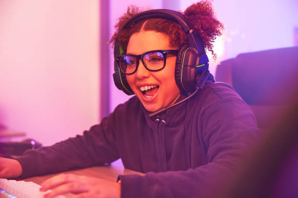 istock Happy, wow or woman gamer on computer with microphone playing games, streaming or fun on tech. Smile, excited or esport player female for online competition, gaming progress or achievement in bedroom 1492872039