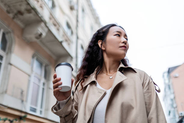 istock Successful young asian businesswoman going to work holding coffee 1492872380