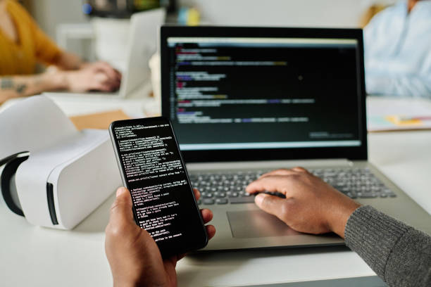 istock Man connecting smartphone to laptop 1492873268
