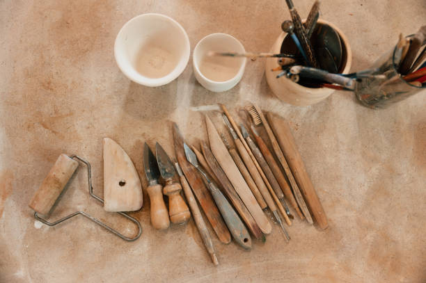 istock Pottery tools. Close up view of the table with instruments 1492874245