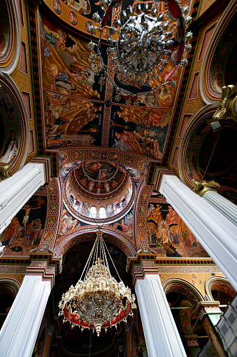 Iraklio, Greece - October 14, 2022: Interior view of the cathedral with religious ceiling paintings and ornate chandeliers of Saint Minas Cathedral in the capital of Crete Island, the orthodox church is dedicated to Saint Menas the martyr and wonderworker