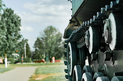 Old tank. Wheels and track closeup and peaceful background. Monument to old weapons close-up. Symbol of the end of the war. Old military weapons. Equipment of the countrys armed forces. Mock up.