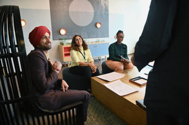 istock Diverse group of engineers team members engaged in a conversation 1492877568