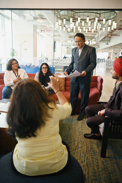 istock Senior man explaining to the diverse group of engineers using his vast experience 1492877569