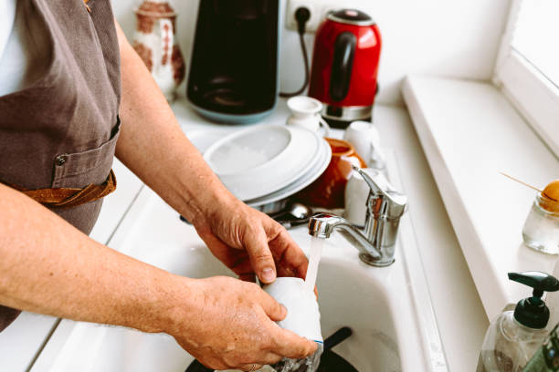 istock Male householder doing housework, washing dishes 1492879352
