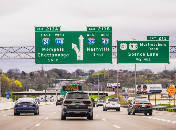 Interstate signs approaching Nashville Nashville, USA - Daytime traffic on Interstate 40 as it approaches Nashville, with signs for upcoming freeway exits. tennessee road sign stock pictures, royalty-free photos & images