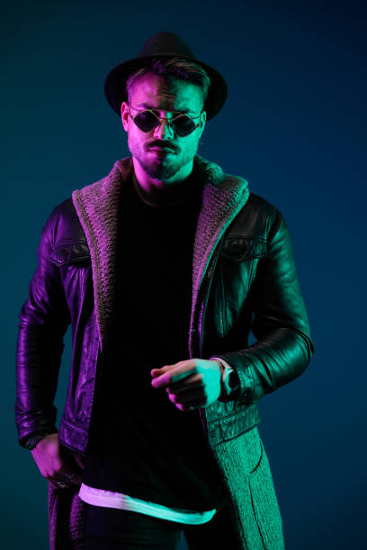 istock casual man wearing nice hat, sunglasses and cardigan 1492881018