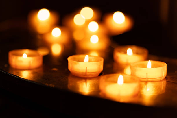 istock burning tea lights in the dark 1492881376