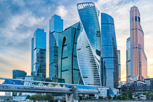 Moscow International Business Center at Sunset: Panoramic View. Panoramic view of the Moscow International Business Center (Moscow-City) during a beautiful sunset. The skyline is dominated by modern skyscrapers that form the bustling business district. The scene showcases the impressive architectural ensemble against the backdrop of a colorful evening sky. The viewpoint from Tarasa Shevchenko Embankment provides a captivating perspective of this renowned urban landmark. moscow city stock pictures, royalty-free photos & images