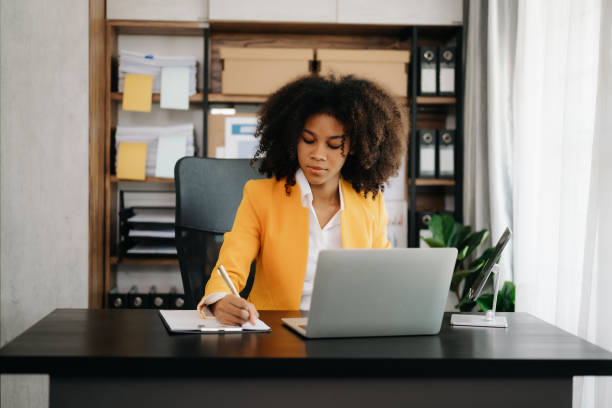 istock African businesswoman working in the office with working notepad, tablet and laptop documents 1492884912