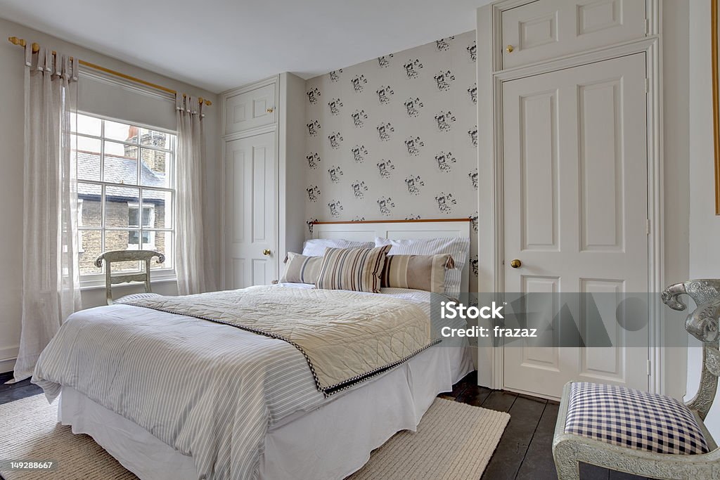 Traditional Bedroom Decor Traditional style bedroom decor within victorian home with dressed bed and wardrobes Bed - Furniture Stock Photo