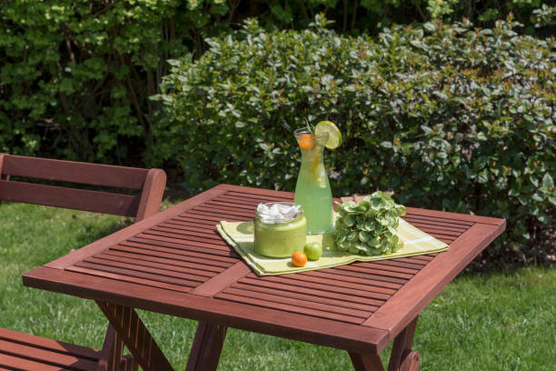 Garden furniture at springtime \nThe background is green tree branches.