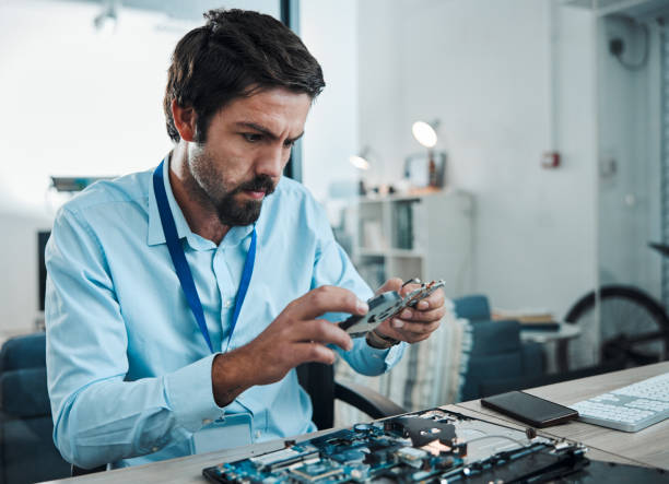 istock Man, circuit and hard drive in repair workshop for maintenance, computer tech or industry with focus. Technician, motherboard and information technology at desk for electronics, engineering and tools 1492887699